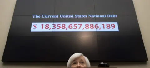 Getty Images A graphic shows the rising current US national debt as Federal Reserve Chair Janet Yellen testifies before the House Financial Services Committee on Capitol Hill in Washington, DC, November 4, 2015