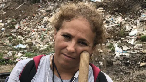 Maria Isabel Cruz takes a break from digging for human remains