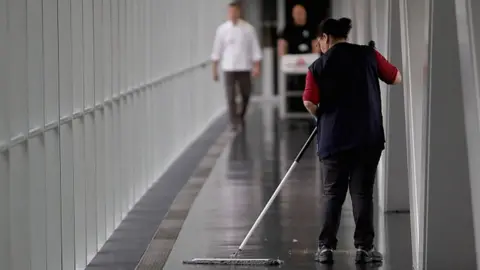 Getty Images Cleaner sweeps the floor of a bridge linking the European Parliament and the Winston Churchill Building on May 12, 2016