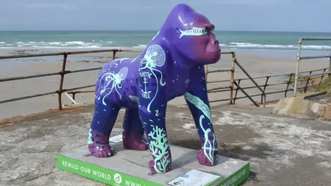 Gorilla statue in front of beach