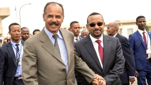 Reuters Isaias and Abiy hold hands