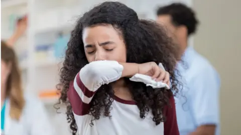 Getty Images Woman coughing