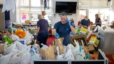 Getty Images volunteers in food bank