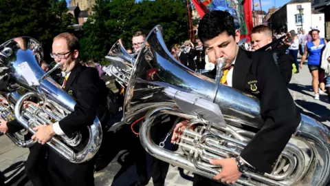 AFP/Getty Images Chaps play musical instruments