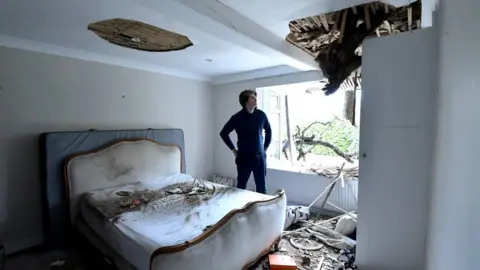 PA Media Sven Good in one of the bedrooms that has been damaged by the fallen tree