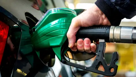 Getty Images Man filling car with fuel
