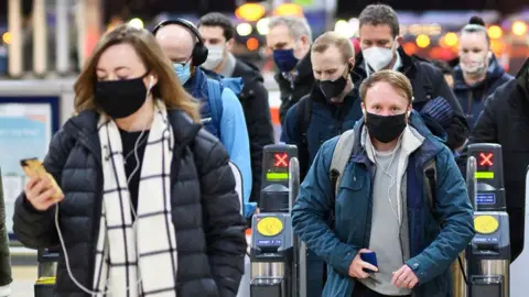 Getty Images People wearing masks arriving in Paddington