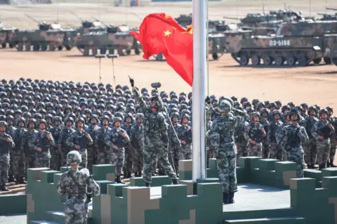 AFP/Getty Images The Chinese flag is raised during a military parade at the Zhurihe training base in China's northern Inner Mongolia region on 30 July 2017