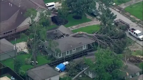 Fallen tree lies on house in Texas