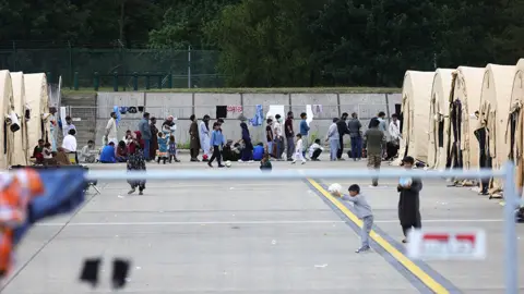 Getty Images Evacuees from Afghanistan are seen at a temporary emergency shelter at the Ramstein Air Base - 26 August 2021