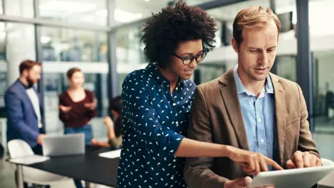 Getty Images Man and woman working with a tablet