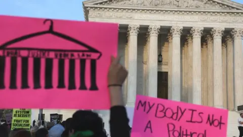 Getty Images the US supreme court building with a protest placard in front reading 'my body is not a political playground'