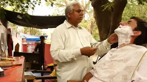 Balwant shaving Justin's beard