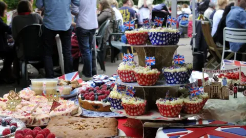 Getty Images A table full of cakes in a street party