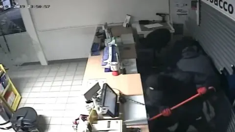 Gloucestershire Constabulary One gang member used a crowbar to break a the till as others packed away cigarettes at Tesco in Southam