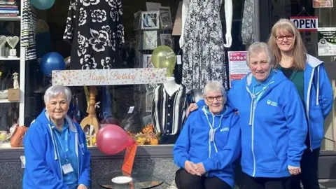 Volunteers and staff at the information point and charity shop