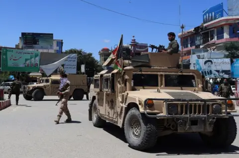 Getty Images Afghan security forces sit in a Humvee vehicle amid ongoing fighting between Taliban militants and Afghan security forces in Kunduz on May 19, 2020