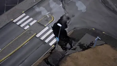 Long fissure splitting a road in Iceland