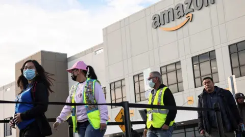 Reuters Amazon workers in New York in line to vote in a union election on 25 March 2022