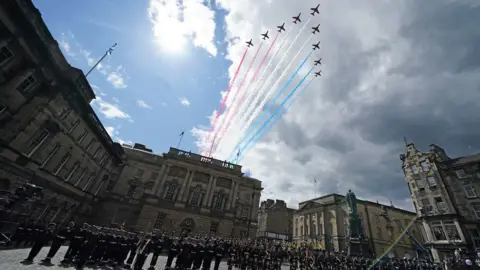 PA Media Red Arrow planes fly over Parliament square in Edinburgh