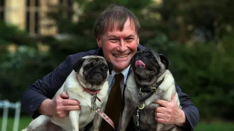 PA Media David Amess and his dogs