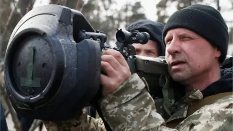 Reuters A new member of the Territorial Defence Forces trains to operate an NLAW anti-tank launcher