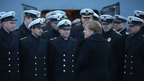Getty Images German Chancellor Angela Merkel talks to sailors of the German Navy while she visited the 'Braunschweig' warship on January 19, 2016 in Kiel, Germany.