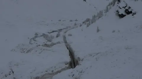 Alain Duclos Workers cut through snow wall on the Bessans to Bonneval-sur-Arc road in France