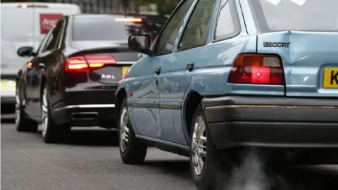 DANIEL LEAL-OLIVAS/AFP via Getty Images Vehicle exhaust