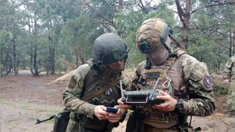 Belarus Ministry of Defence A Wagner mercenary training a Belarus soldier at a camp near the Polish border