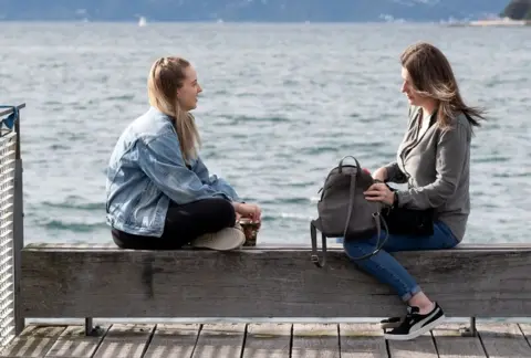  AFP/Getty Images Women sit on the waterfront in Wellington on May 14, 2020.