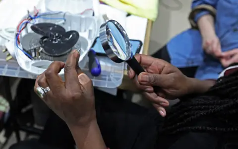 BBC Volunteers repair electrical items at the Fixing Factory in Camden, London