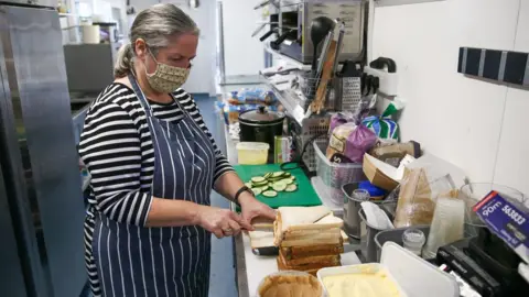 PA Media Fiona Crump, owner of the Castle Beach Cafe in Falmouth, will make free lunch bags during half term