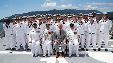 Reuters Prince Charles poses for photos with the crew of HMAS Melville during his visit to HMAS Cairns