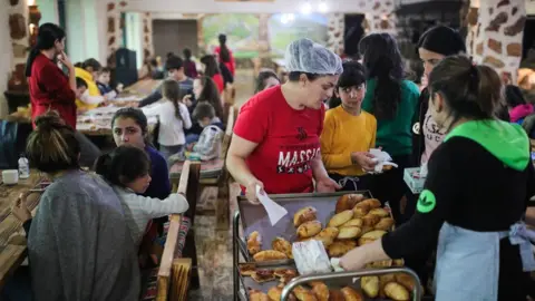 Getty Images Refugees from Nagorno-Karabakh have their meals at a hotel in the Armenian town of Goris