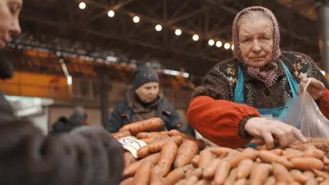 Max Lomakin A Moldovan woman puts carrots in a bag