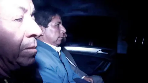 Getty Images Former President Pedro Castillo seen inside a police car in Lima