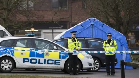 Getty Images Police officers near a forensic tent in Salisbury