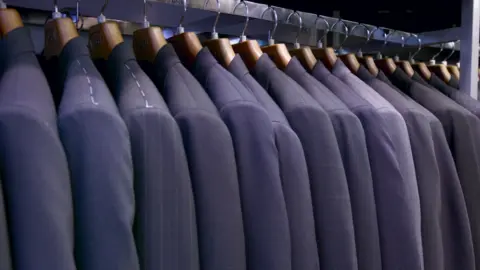 Jupiterimages Suits hanging on a rack