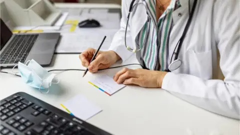 Getty Images Doctor writing