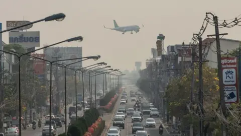 Getty Images Airplane flies above polluted Chiang Mai, Thailand.