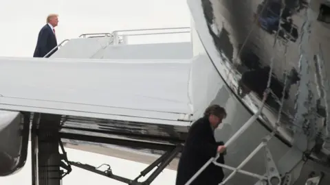 Getty Images US President Donald Trump and Steve Bannon board Air Force One in Palm Beach, Florida, in March 2017.