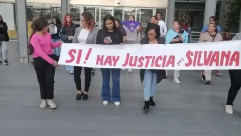 Courtesy of Garrido family The Garrido family and their supporters hold a banner reading "Yes! There is justice for Silvana"