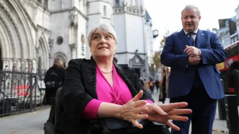 PA Media Sal Brinton and Ian Blackford