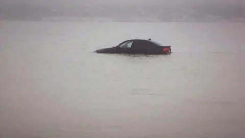 Borth Coastguard Rescue Team A car submerged in the sea