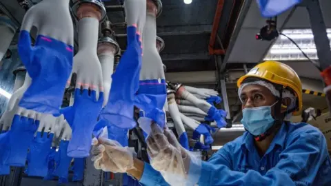 Getty Images Worker in Top Glove factory in Malaysia