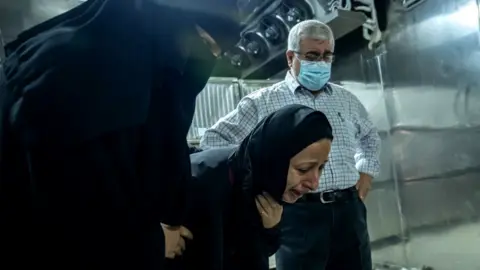 Getty Images A woman mourns for her relatives who were killed during an Israeli raid on Gaza City on May 16