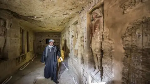 Getty Images An overseer of diggers in Egypt walks into a newly-discovered tomb of the high priest Wahtye, who served during the fifth dynasty reign of King Neferirkare between 2500-2300 BC.