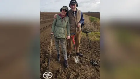 Noonans Paul Shepheard and wife Joanne in a field with metal detectors