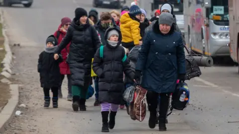 Getty Images Refugees arriving at the Polish border.